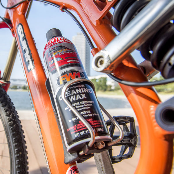 FW1 car wash and wax in the bottle holder of an orange bike 