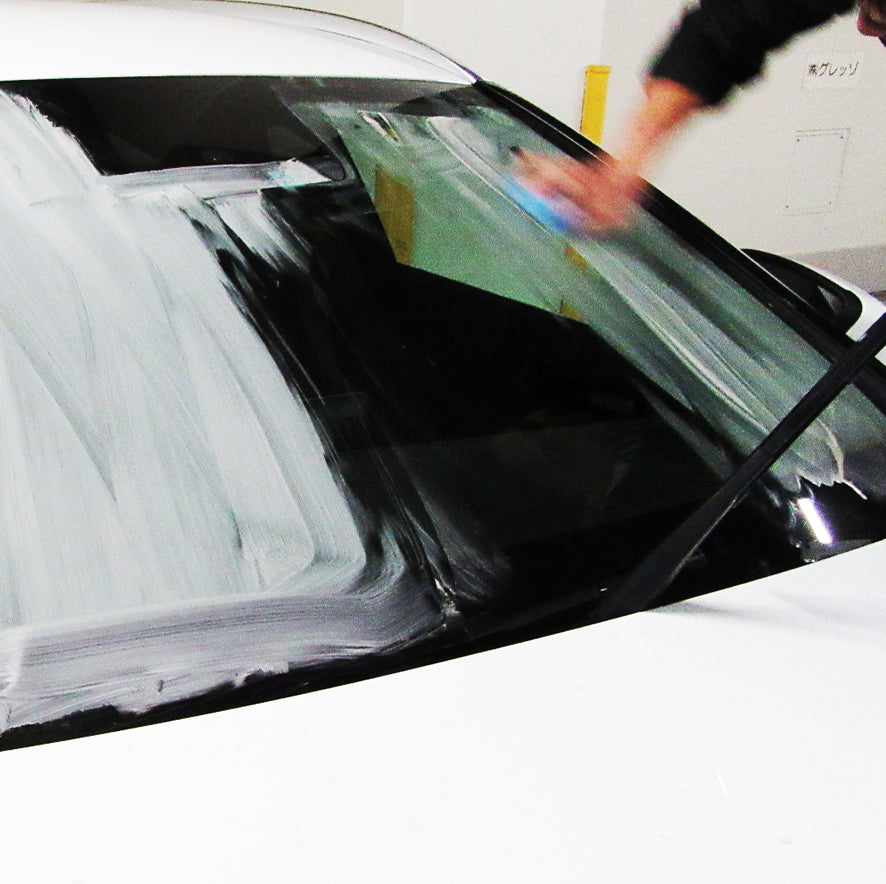 white substance being wiped off a windshield