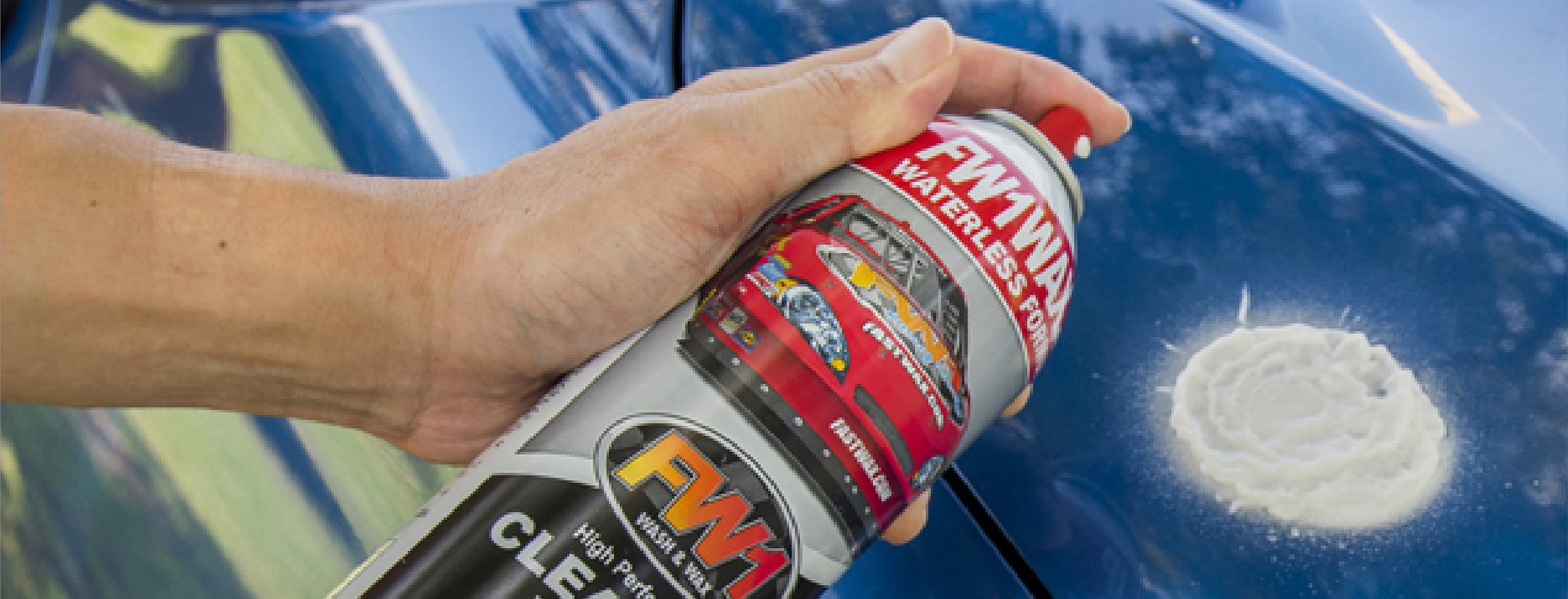 FW1 car wash and wax being sprayed on a blue car