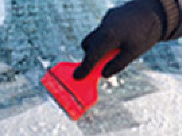 someone trying to scrape ice off a car's rear window 