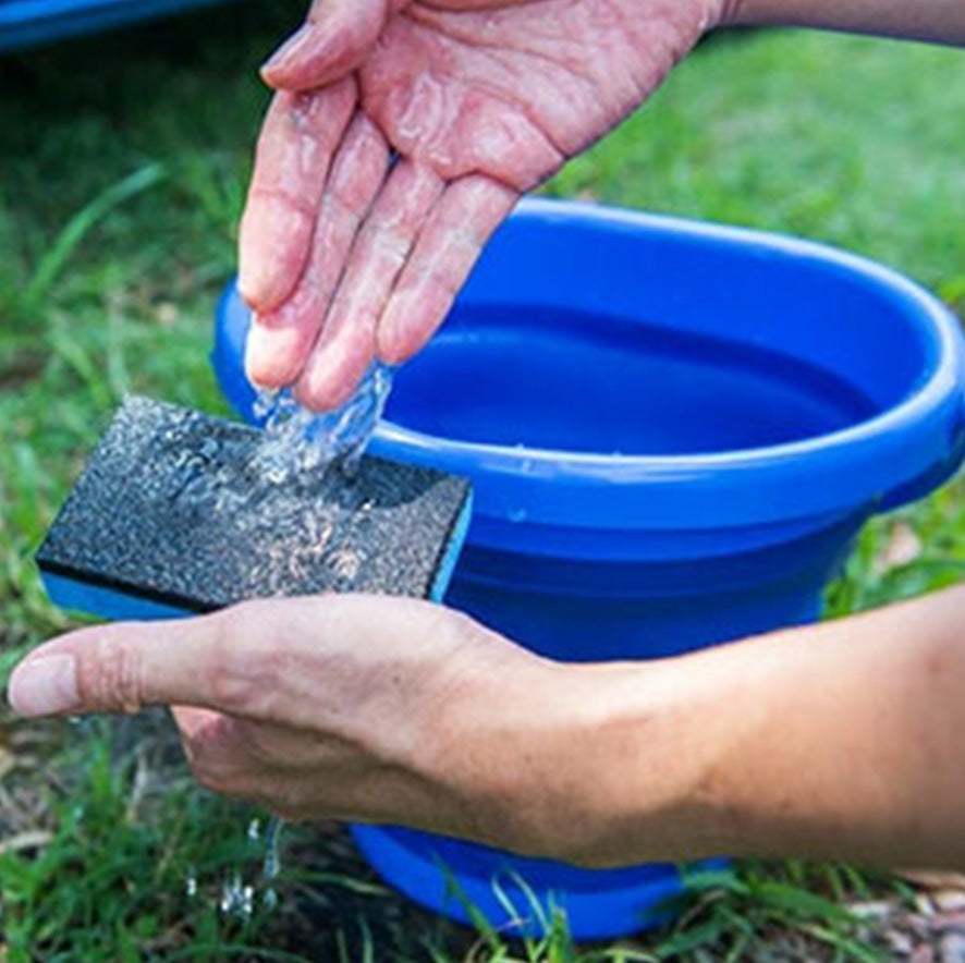 water being poured onto a blue sponge