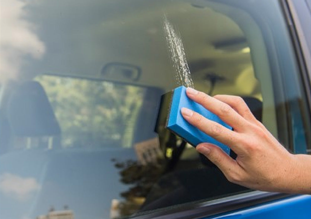 gc zero glass cleaner being used on a car window