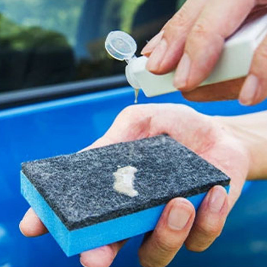 gc zero glass cleaner being poured onto a blue sponge 